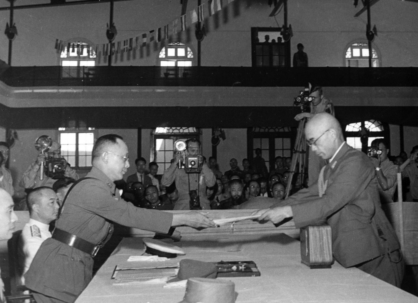  In 1945, on what would become known as Retrocession Day, Chief Executive of Taiwan Province Chen Yi (right) accepting the surrender of Taiwan from Rikichi Andō (left), the last Japanese Governor-General of Taiwan, on behalf of the Republic of China Armed Forces at Taipei City Hall. (Credit: POWWII)